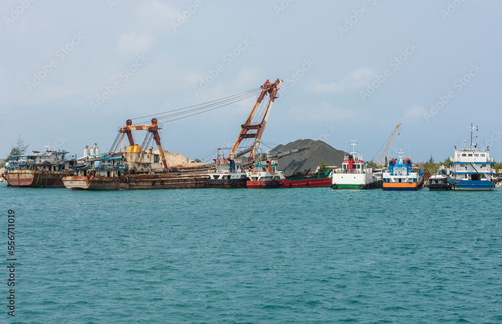 Small industrial cargo ships in commercial industrial port