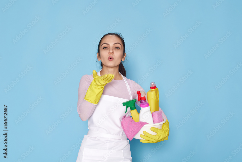 woman in gloves and cleaner apron with sponge and detergent sprayer woman in gloves and cleaner apron with sponge and detergent sprayer