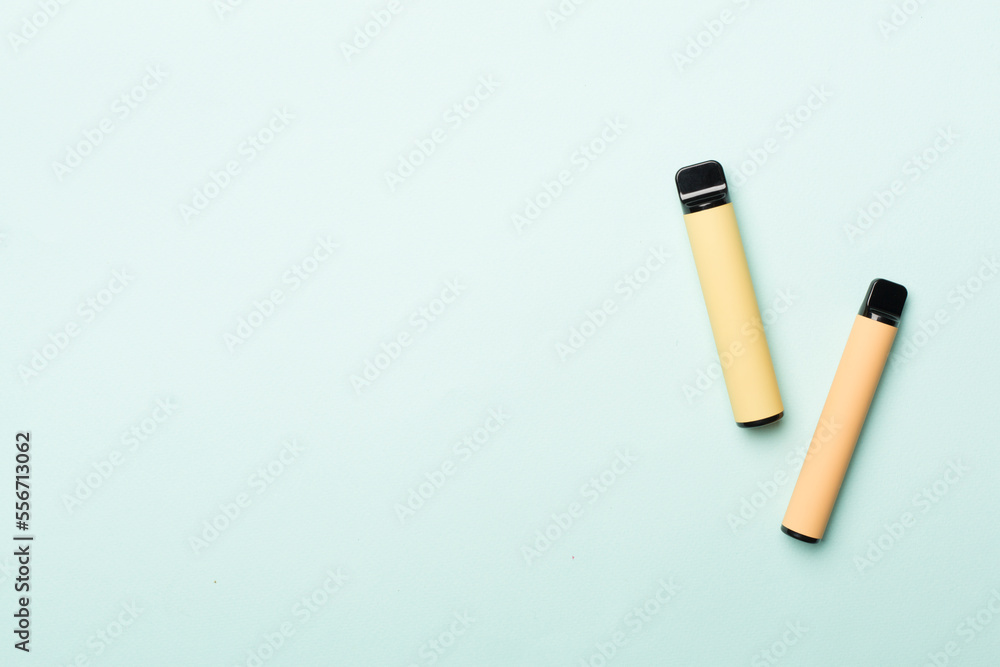 Disposable electronic cigarettes on color background, top view Disposable electronic cigarettes on color background, top view