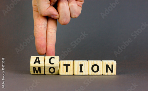 Action or motion symbol. Concept word Motion and Action on wooden cubes. Businessman hand. Beautiful grey table grey background. Business and action or motion concept. Copy space.