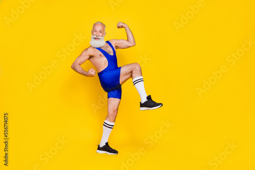 Obraz na plátně Profile full length photo of handsome strongman grandfather wear sport costume d