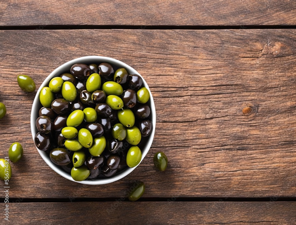 olives in a bowl on a wooden table olives in a bowl on a wooden table