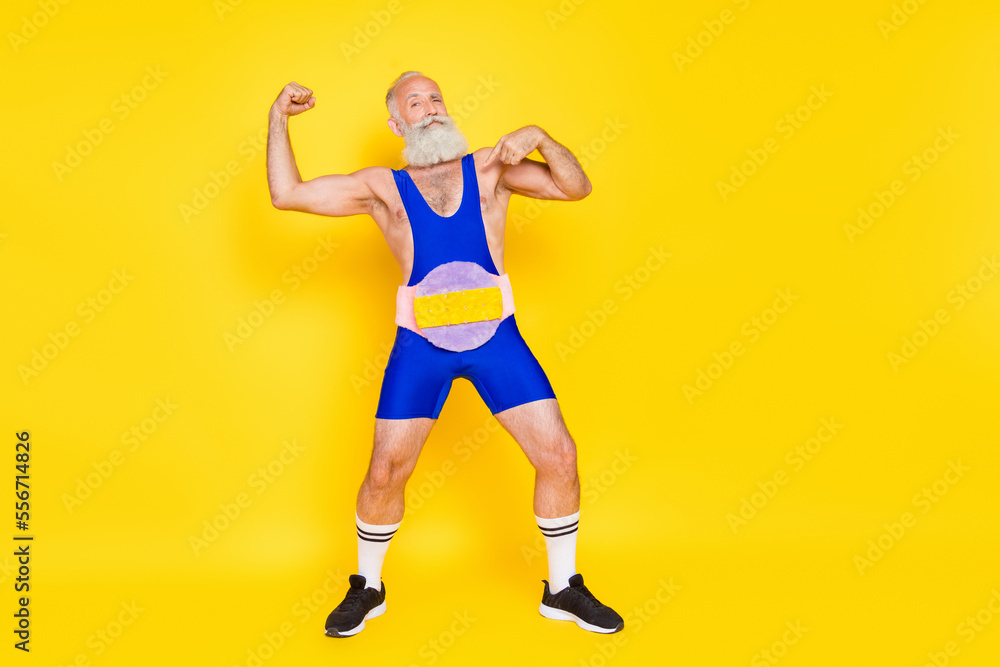 Full length portrait of confident grandfather point finger himself show biceps wear fluffy soft belt isolated on yellow color background