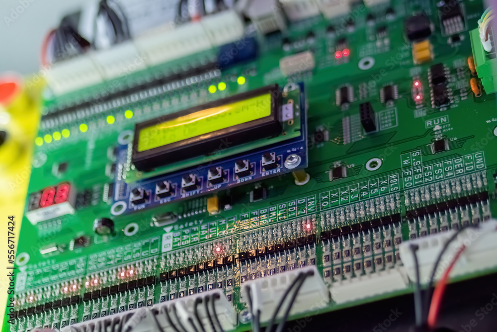 Printed circuit board - pcb for elevator with digital display module at lift exhibition, trade show - close up view. Technology and electronic concept Printed circuit board - pcb for elevator with digital display module at lift exhibition, trade show - close up view. Technology and electronic concept
