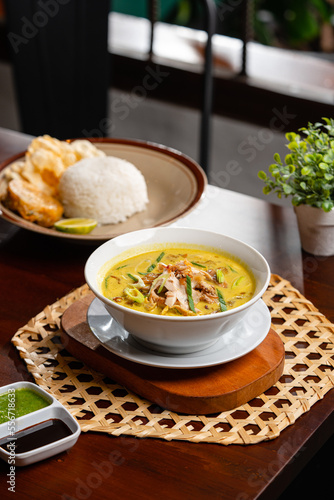 Soto ayam is a typical Indonesian food in the form of a kind of chicken soup with a yellowish sauce. photo