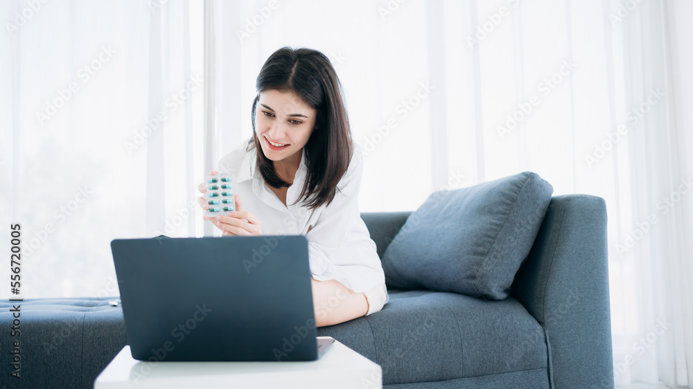Woman engages in a videoconference with a doctor through her smartphone while at home in isolation under hospital quarantine. Woman engages in a videoconference with a doctor through her smartphone while at home in isolation under hospital quarantine.