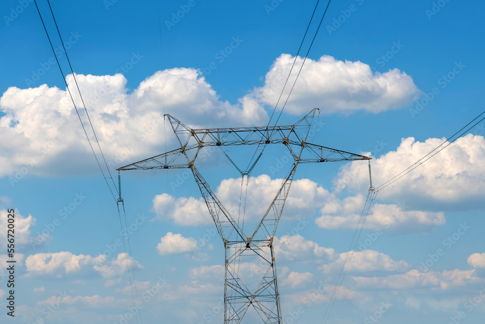 High voltage pylon on cloudy sky background