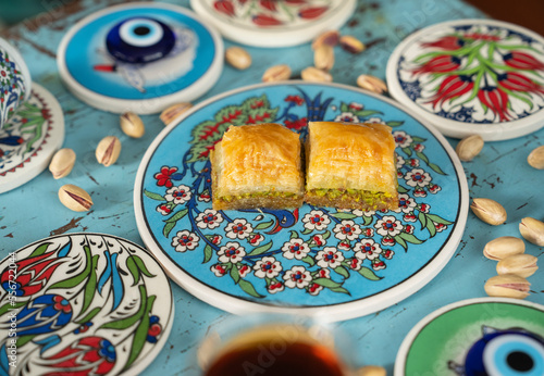 Photograph of Turkish Baklava in Ottoman Tile Turkish Coffee Cup and Turkish Tea Concept, Uskudar Istanbul, Turkey photo