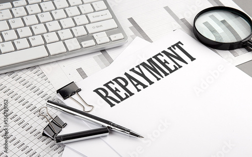 REPAYMENT text on paper with chart and keyboard, business concept