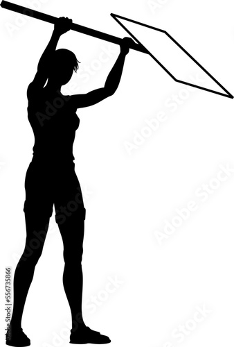 Protestor or demonstrator at a demonstration march, picket line or strike protest rally in silhouette. Holding up a banner or picket sign board placard.