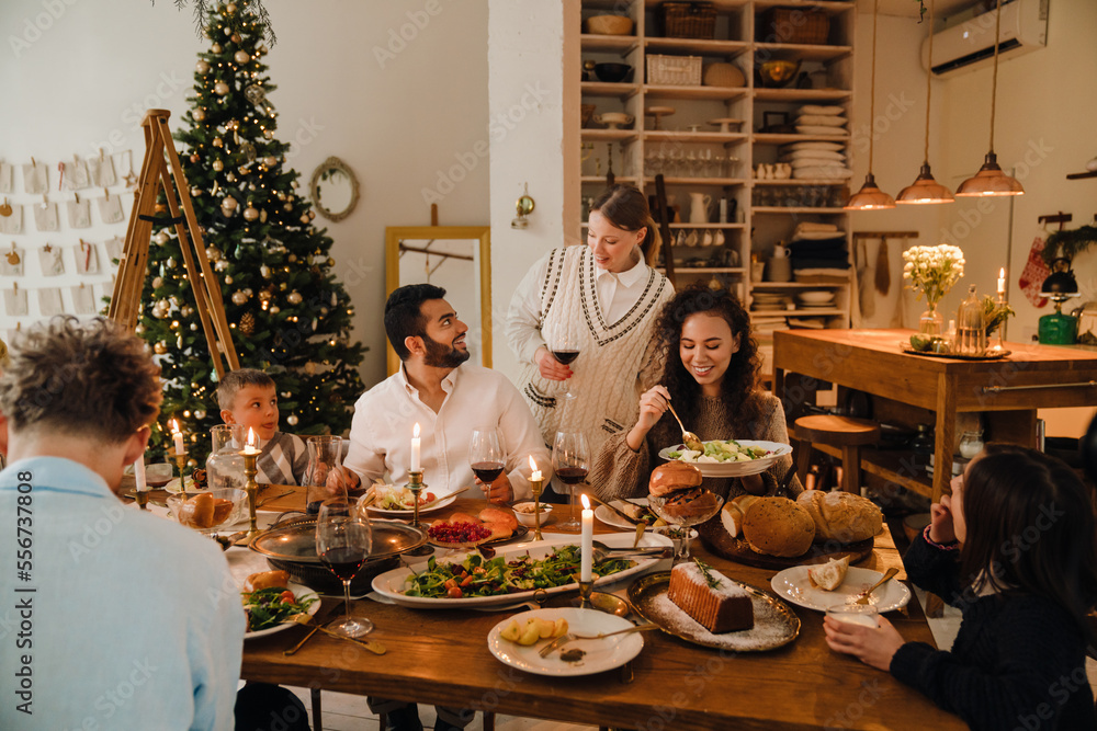 Joyful family having traditional dinner together during Christmas holidays