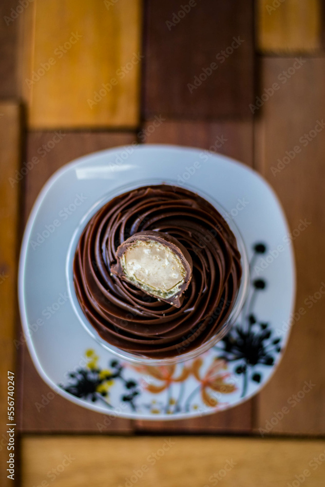 Mousse and pot cake, chocolate, strawberry and other creams, sugared strawberry, with chocolate bonbon, spoon, fabric, rustic wood Mousse and pot cake, chocolate, strawberry and other creams, sugared strawberry, with chocolate bonbon, spoon, fabric, rustic wood