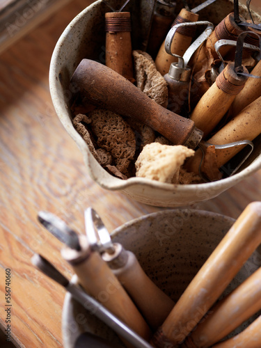 pottery making tools for cutting, edging, trimming, and sponging clay standing in clay pots, Canada photo