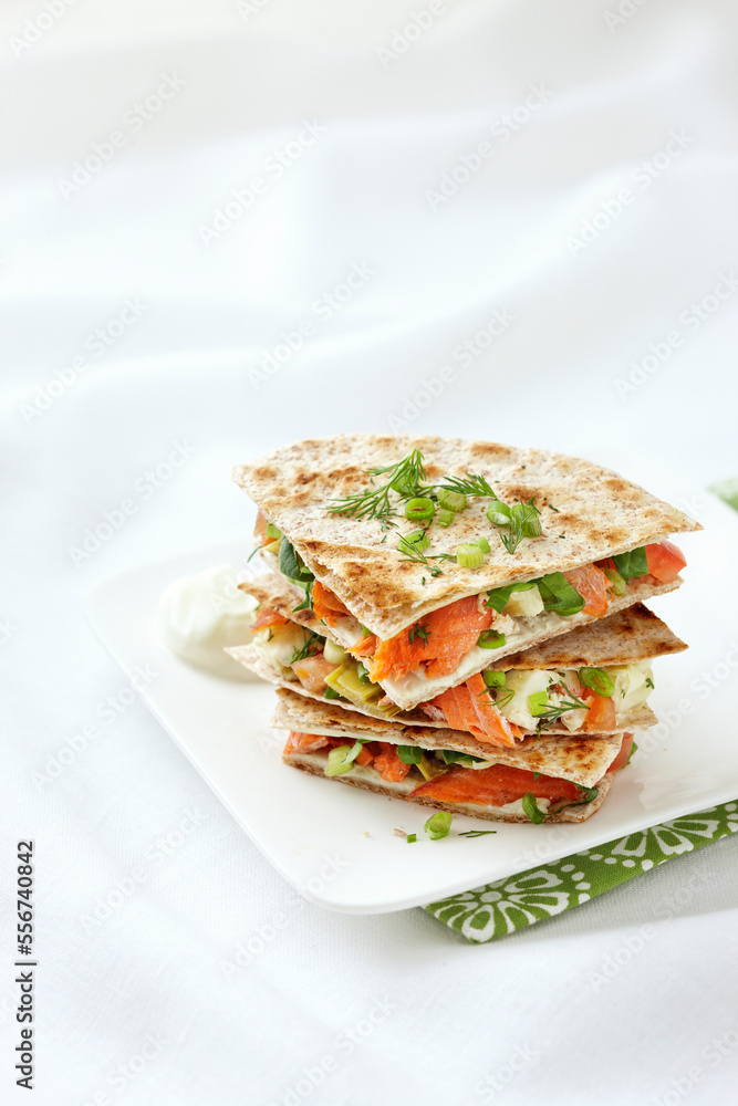 Stack of Smoked Salmon Quesadillas with Artichoke Hearts, Cream Cheese, Dill, Green Onions, Spinach, and Tomatoes on Whole Wheat Tortillas Stack of Smoked Salmon Quesadillas with Artichoke Hearts, Cream Cheese, Dill, Green Onions, Spinach, and Tomatoes on Whole Wheat Tortillas