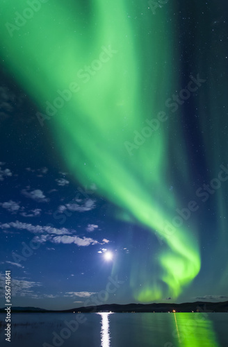 Bright green aurora with moon flaming over Harding Lake, Interior Alaska in autumn; Fairbanks, Alaska, United States of America photo