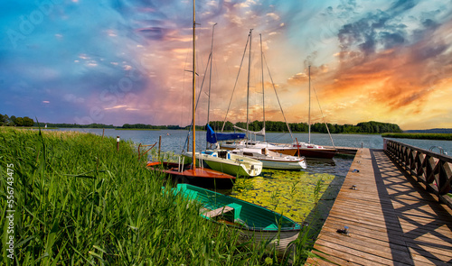 White yachts at the wooden pier on the lake