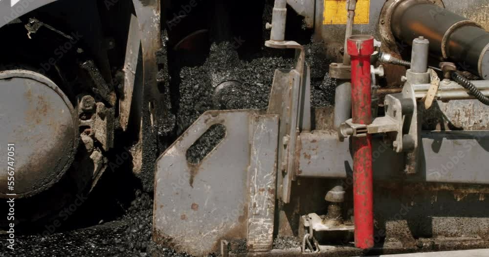 Asphalt laying. Road building asphalt paver is laying a new layer of asphalt, Road rollers drive on a new road. Roadway repair. Heavy machinery. Asphalt Road Construction Asphalt laying. Road building asphalt paver is laying a new layer of asphalt, Road rollers drive on a new road. Roadway repair. Heavy machinery. Asphalt Road Construction