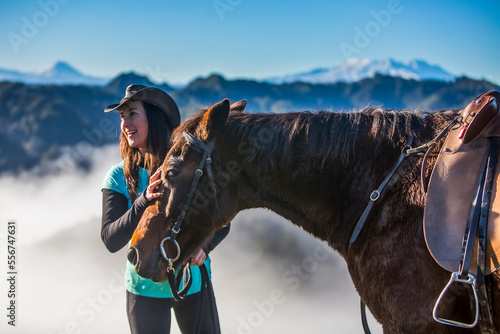 Cowgirl with her horse, Blue Duck Station, Whanganui National Park, Whakahoro, New Zealand photo