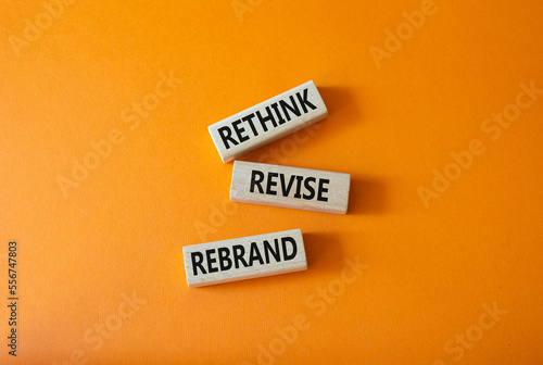 Rethink Revise Rebrand symbol. Wooden blocks with words Rethink Revise Rebrand. Beautiful orange background. Business and Rethink Revise Rebrand concept. Copy space. photo