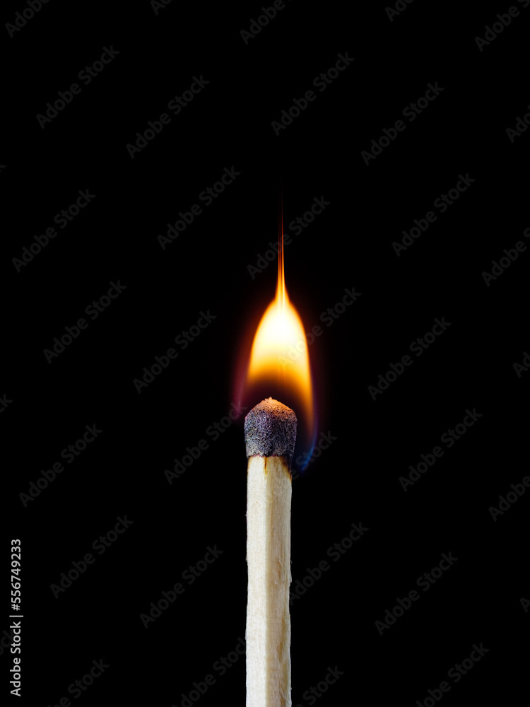 Macro shot of a wood safety matchstick burning with a bright flame Macro shot of a wood safety matchstick burning with a bright flame