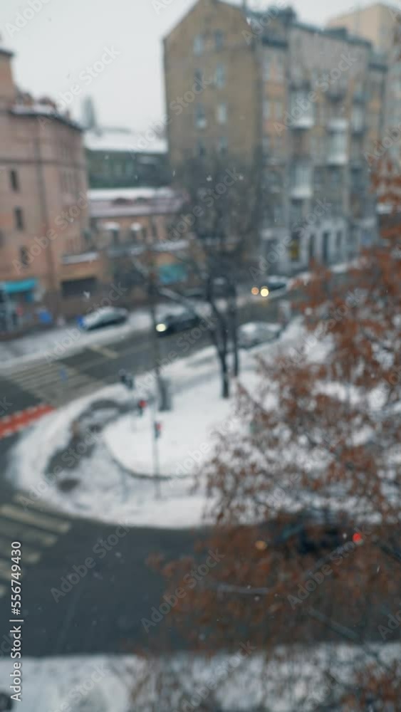 Panoramic view of a city street during snowfall. City life in winter Panoramic view of a city street during snowfall. City life in winter