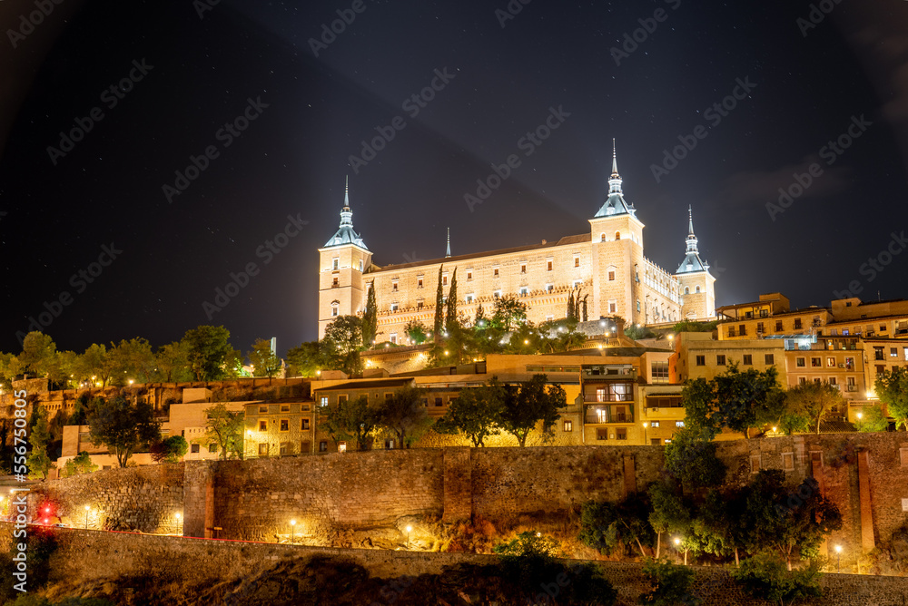 Toledo downtown lights with Alcazar castle on top - obrazy, fototapety, plakaty 