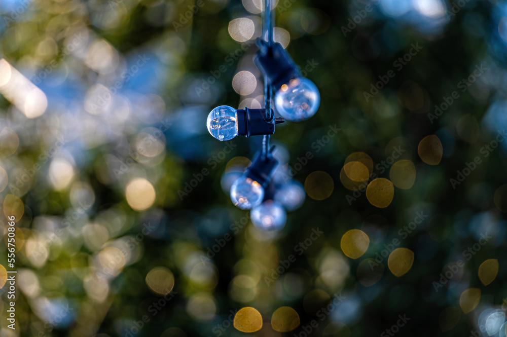 garland of light bulbs on defocused festive lights background, shallow depth of field, copy space garland of light bulbs on defocused festive lights background, shallow depth of field, copy space
