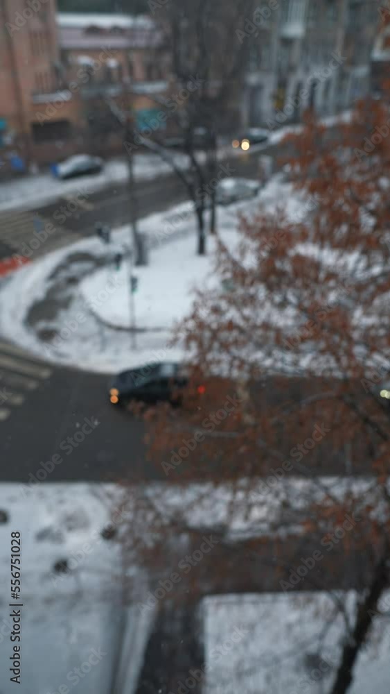 Panoramic view of a city street during snowfall. City life in winter Panoramic view of a city street during snowfall. City life in winter