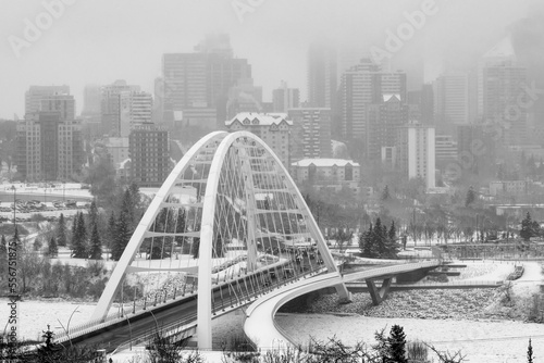 Walterdale Bridge crossing the frozen North Saskatchewan River in the city of Edmonton in winter; Edmonton, Alberta, Canada photo