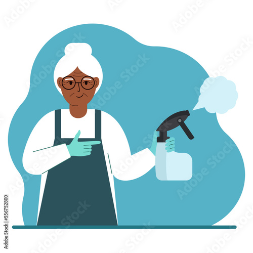 A woman in gloves holds a spray bottle with disinfectant liquid, antiseptic or detergent. Home disinfection and hygiene.