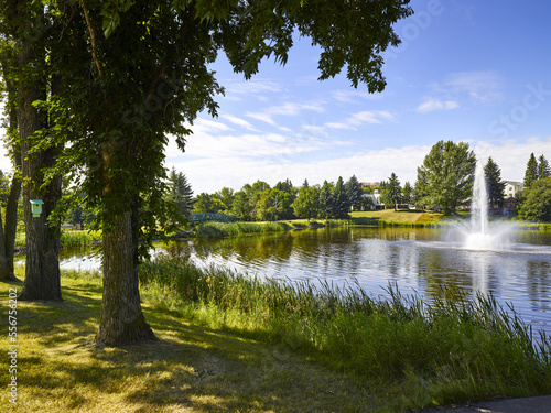 Fountain and footbridge on Mirror Lake in the community of Camrose; Camrose, Alberta, Canada