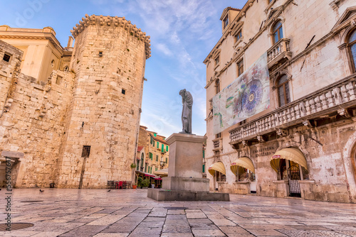 Venetian Castle and statue of Croatian poet Marko Marulic in Radic Brothers Square in the city centre of Split; Split, Croatia photo