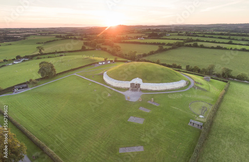 Aerial view of a sunset and surrounding farmland at the ancient passage tomb and temple of Newgrange, a Neolithic monument at the Bru na Boinne Heritage Site; Donore, County Meath, Ireland photo