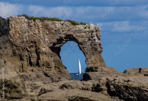 Wherry viewed through a natural arch rock formation; Whitburn Tyne and Wear, England photo