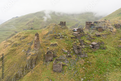 The mountainside village of Kvavlo with its stone houses and ruins of medieval watch towers overlooking the village of Darlto in Tusheti National Park; Kvavlo, Kakheti, Georgia photo