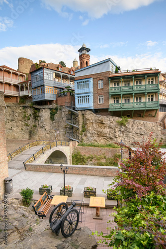 Old wooden buildings built on the cliffs of Tbilisi's old town in the country of Georgia photo