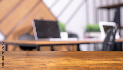 Blurred office background with modern workplaces and wooden desk, wood table. High quality photo