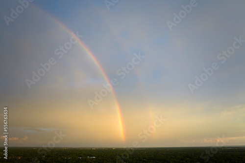 Fototapeta Naklejka Na Ścianę i Meble -  Colorful round rainbow against blue evening sky after heavy thunderstorm