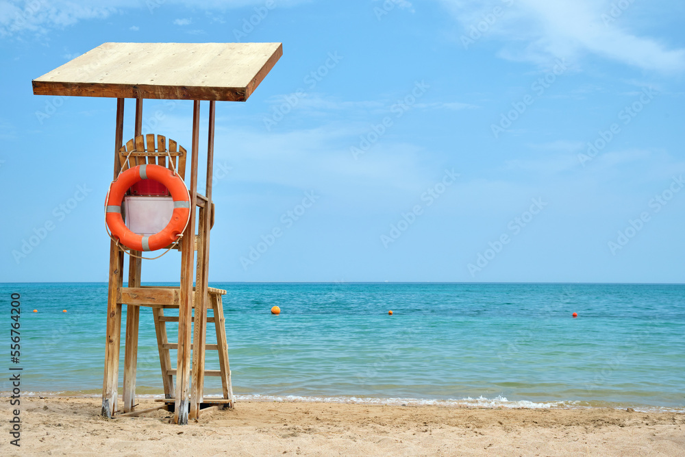 Emplty wooden lifeguard station on sandy beach on ocean shore in summer Emplty wooden lifeguard station on sandy beach on ocean shore in summer