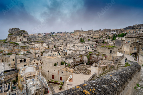 Cityscape panorama overlooking the ancient cave dwellings of the Sassi di Matera with Santa Maria de Idris church on the left; Matera, Basilicata, Italy photo