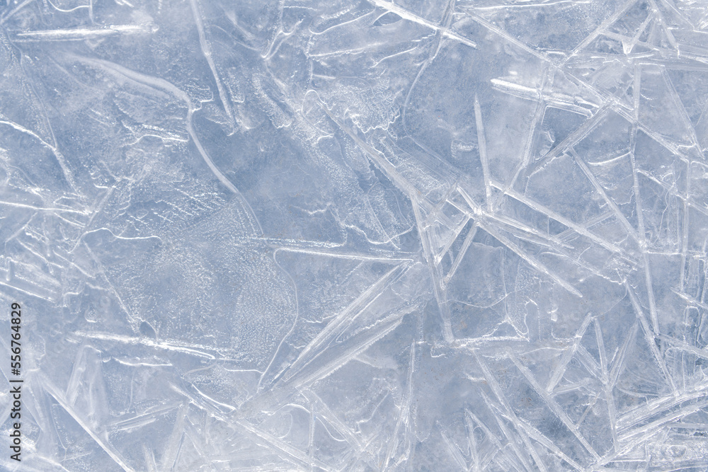Obraz premium Abstract textured white ice cracked background. Thin ice on river surface. Copy space for your text and decorations. Beauty in winter nature theme.