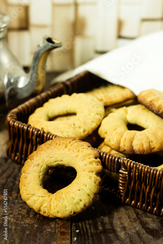 Traditional festive Algerian Kaak dry cookies ring named " kaak of tlemcen in arabic " tlemcen is a town in algeria in basket and teapot