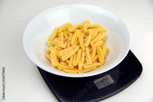 Weighing 100 grams of pasta on a digital scale
