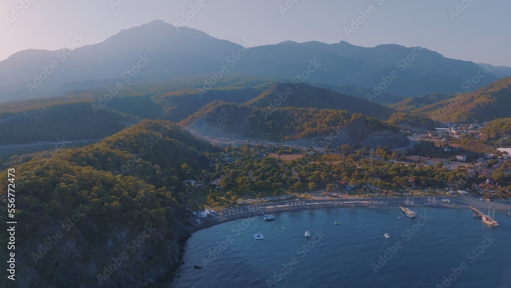 Seascapes shore at sunset. Panorama view of the blue bay against the backdrop of a mountain landscape. Seascapes shore at sunset. Panorama view of the blue bay against the backdrop of a mountain landscape.