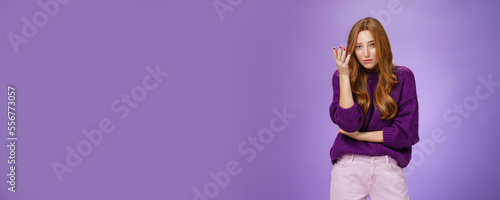 Jeez what you saying. Portrait of redhead 20s female student making facepalm gesture raising eyebrows and looking questioned at camera as being annoyed with dumb and nonsense conversation photo