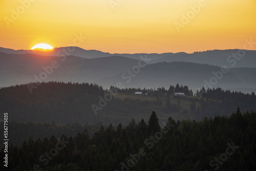 Dawn over the Carpathian Mountains near Tasuleasa Social NGO for the Via Transilvanica trail through Transylvania as the sun rises above the horizon; Transylvania, Romania photo