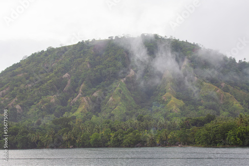 Steam rising from the jungles of Dobu Island in the D'Entrecasteaux Islands, Papua New Guinea; Dobu Island, D'Entrecasteaux Islands, Papua New Guinea photo