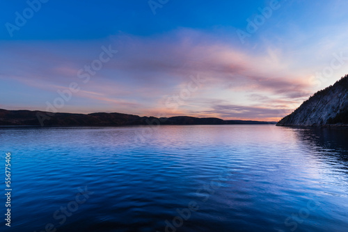 Saguenay Valley at sunset, viewed from the dock of Sainte-Rose-du-Nord along the Saguenay River in Quebec; Saint-Rose-du-Nord, Quebec, Canada