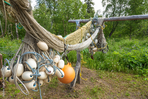 Salmon drift nets with floats and buoy hung up to dry at a remote fish camp in summer, Kuskokwim River; Kalskag, Southwestern Alaska, Alaska, United States of America