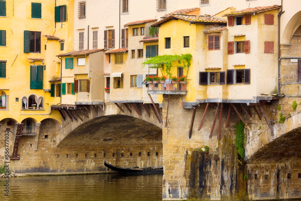 A plant covered terrace along the medieval bridge of Ponte Vecchio crossing the Arno River; Florence, Tuscany, Italy A plant covered terrace along the medieval bridge of Ponte Vecchio crossing the Arno River; Florence, Tuscany, Italy